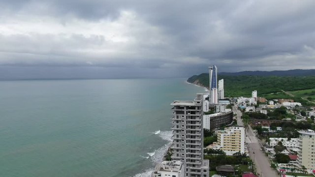 Aerial view of Tonsupa Beach in Ecuador, lots of buildings on a cloudy day
