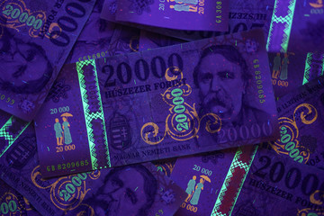 Check the authenticity of money. 20000 Hungarian forint banknote in UV light to verify authenticity...