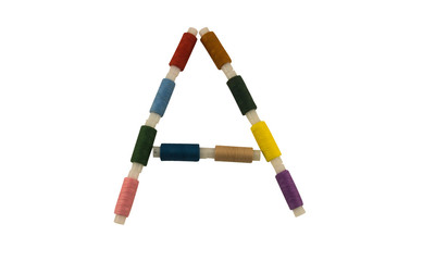 Isolated Font English or Latin or Russian letter A colorful spools of thread for sewing on white background