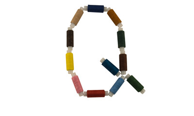 Isolated Font English or Latin Letter Q made of colorful spools of thread for sewing on white...