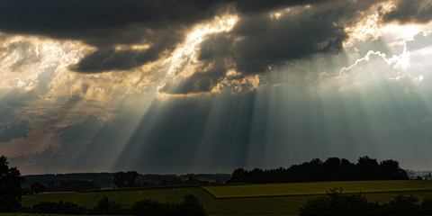 sunrays in the sky with dramatic thunderclouds