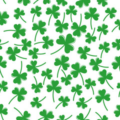 Seamless pattern with green clover the symbol of St. Patrick's day. Vector illustration with shamrock symbol of Ireland, hand drawn in doodle on color background for design, kids decor, wrapping