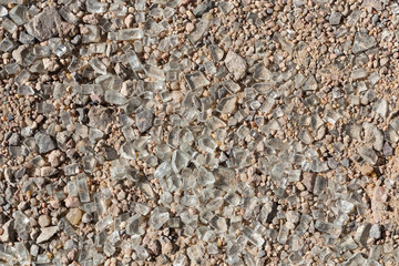 Broken glass on the asphalt. Traces of a car accident on the ground. After the disaster.