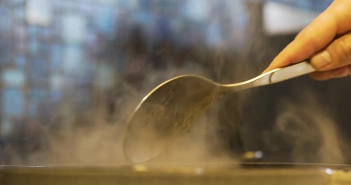 the cook cooks mussels in the pan