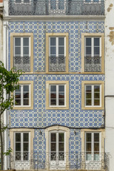 Fototapeta na wymiar Tile covered colourful building exterior in Lisbon, Portugal.
