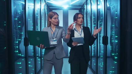 Data center. IT administrator and server engineer inside server room discussing network and data issues inspecting supercomputer and cooperating at database. - Powered by Adobe