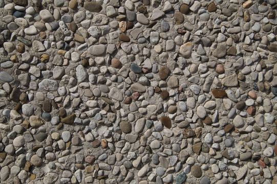Texture of stone wall covered with pebbles
