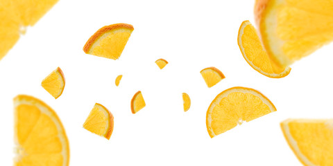 Orange background. Citrus fruit tangerine slices falling on white with clipping path.