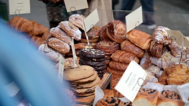 Pastries and cookies piled high and ready for sale at a stall in Borough Market, London