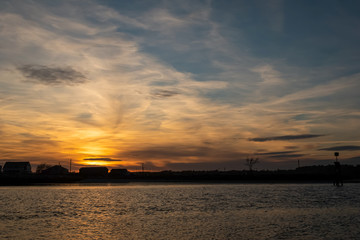 Fototapeta na wymiar Sunset at low tide on Drakes Island looking into Wells Harbor - Wells, Maine.