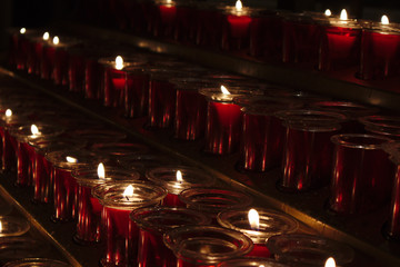 Close-up of some red candles burning in a church