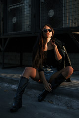 Naklejka premium Pretty young sexy fashion model posing on the street.