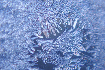 Photographing macro ice on the glass in winter Patterned like