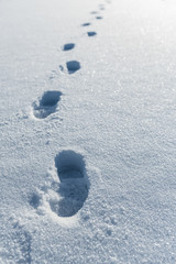Footprint trail in the deep snow. Boot foot prints path in fresh snow