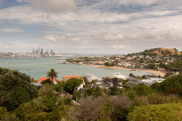 Fototapeta premium The view from North Head over the beach at Torpedo Bay and Devonport, across the Waitemata Harbour to Auckland City and the port in the background.