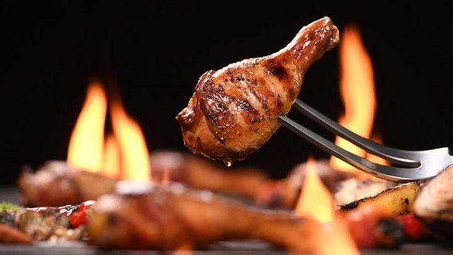 Close up grill roast bbq chicken leg on the flaming grill , 4k