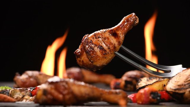 Close up grill roast bbq chicken leg on the flaming grill , 4k