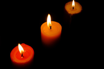 colorful burning candle in dark , close up 