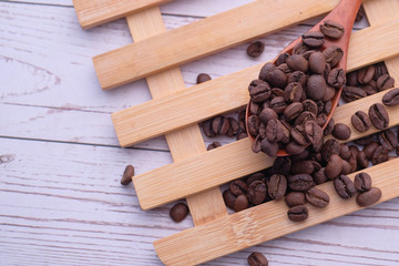 top view of fresh coffee beans on spoon on table 