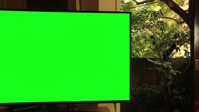Flat Screen Tv with Green Screen in the Living Room. Zoom In. You can replace green screen with the footage or picture you want. You can do it with &ldquo;Keying&rdquo; effect in After Effects.
