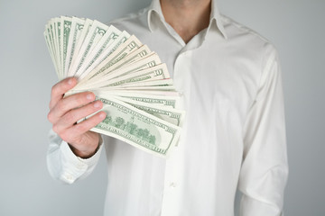 Man holds a lot of money. Concept of wealth, rich living, earning money online.
