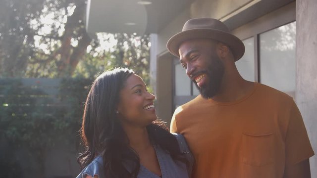 Portrait Of Smiling African American Couple Talking And Laughing In Garden At Home