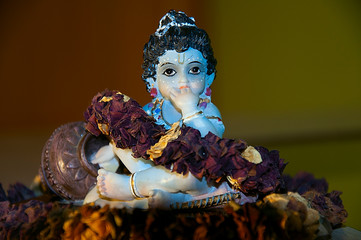 little krishna figurine in flowers