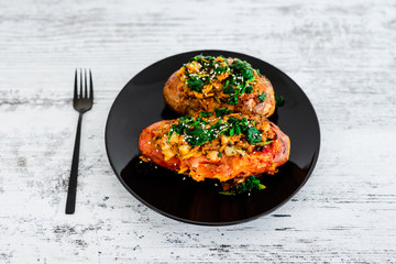 plant-based food, baked veggie-stuffed potato and sweet potato with beans and spinach topping