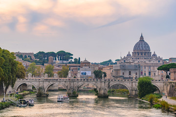 Sunset view of St. Peter's Basilica, Ponte Sant'Angelo, and Tiber River in Rome, Italy