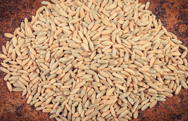 Heap of rye grains on old background structure