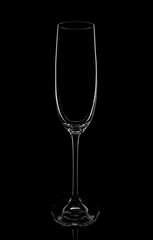 Empty champagne glass on a black background, elegantly illuminated on the sides. Concept, mysterious club life.