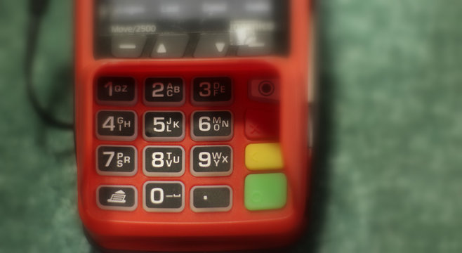 Credit card and card reader on blury background. Selective focus with copyspace for text.