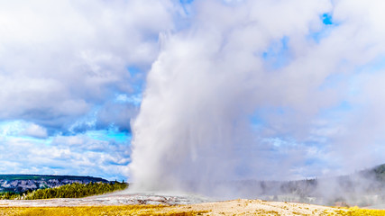 Eruption of the famous Old Faithful Geyser a Cone Geyser in the Upper Geyser Basin along the Continental Divide Trail in Yellowstone National Park, Wyoming, United States