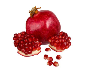 Pomegranate grains and a ripe pomegranate isolated on white background
