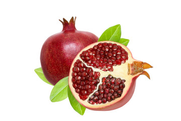 Isolated pomegranate fruit and half of a pomegranate with green garnet leaves. White background.