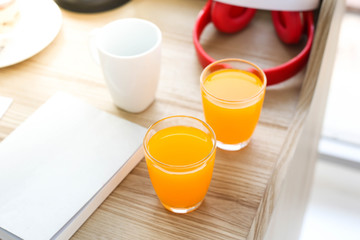 Orange juice on Wood desk decoration with cup of coffee in the morning.