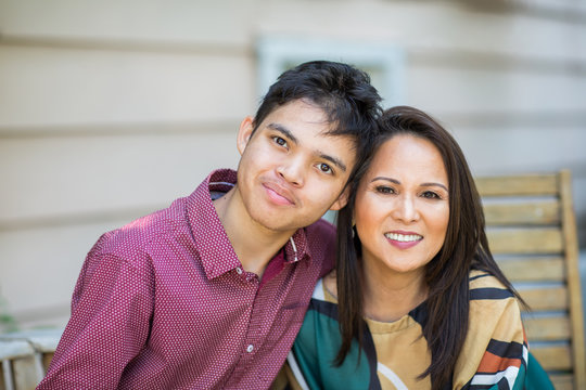 Portrait of an Asian mother with her teenage son.