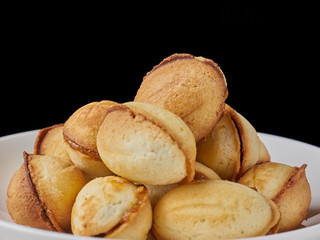 Cookies Shaped Nuts With Condensed Milk close-up on black background