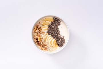 Healthy pineapple, mango smoothie bowl with coconut, bananas, blueberries and granola. Top view scene on a bright background.