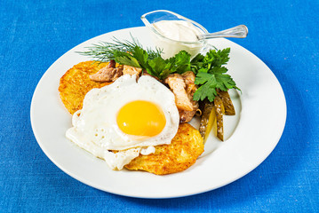 potato pancakes with fried egg and sauce