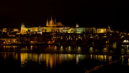 Fototapeta na wymiar Prague, Czech Republic. Amazing landscape of the castle at night. In the foreground the Charles Bridge. View of historical buildings along the river