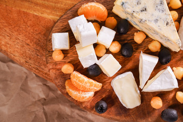a pieces of cheese on wooden Board. Delicious.