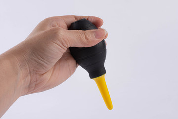 rubber air blower in hand Oliver White background, accessory for dust removing