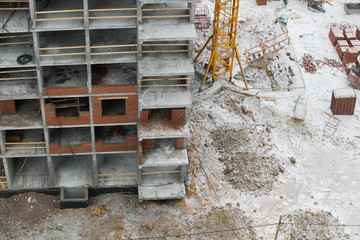 construction of a multi-storey residential building at winter time.