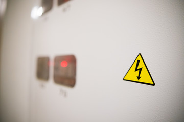 modern electric meters in the house, yellow sign of electricity