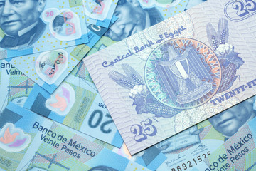 A close up image of an Egyptian twenty five pisatres note with Mexican twenty peso bank notes in macro