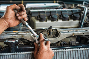 Hands of mechanic working in auto repair shop - 326591082