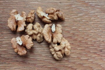 Closeup of peeled walnuts on wooden background