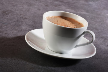 Cup of coffee on gray stone table