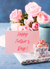 Happy mothers day greetings. Holiday greeting card with lettering text, cup of tea and cupcake